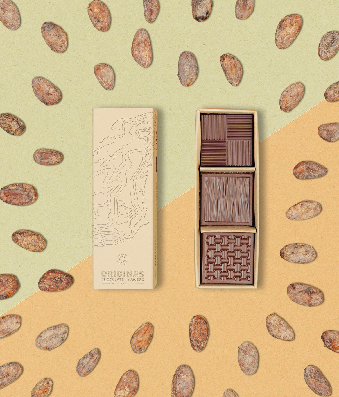 Une boîte rectangulaire de chocolats fins en kraft l'emballage est ouverte, révélant trois carrés de chocolat aux motifs variés, posée sur un de fèves de cacao et un fond géométrique dans les tons orange et vert.